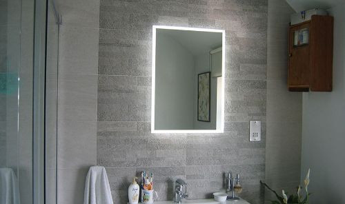 glowing mirror and bathroom tiles